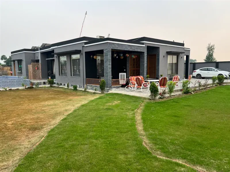 Completed residential bungalow with lawn and pool by Planet Builders